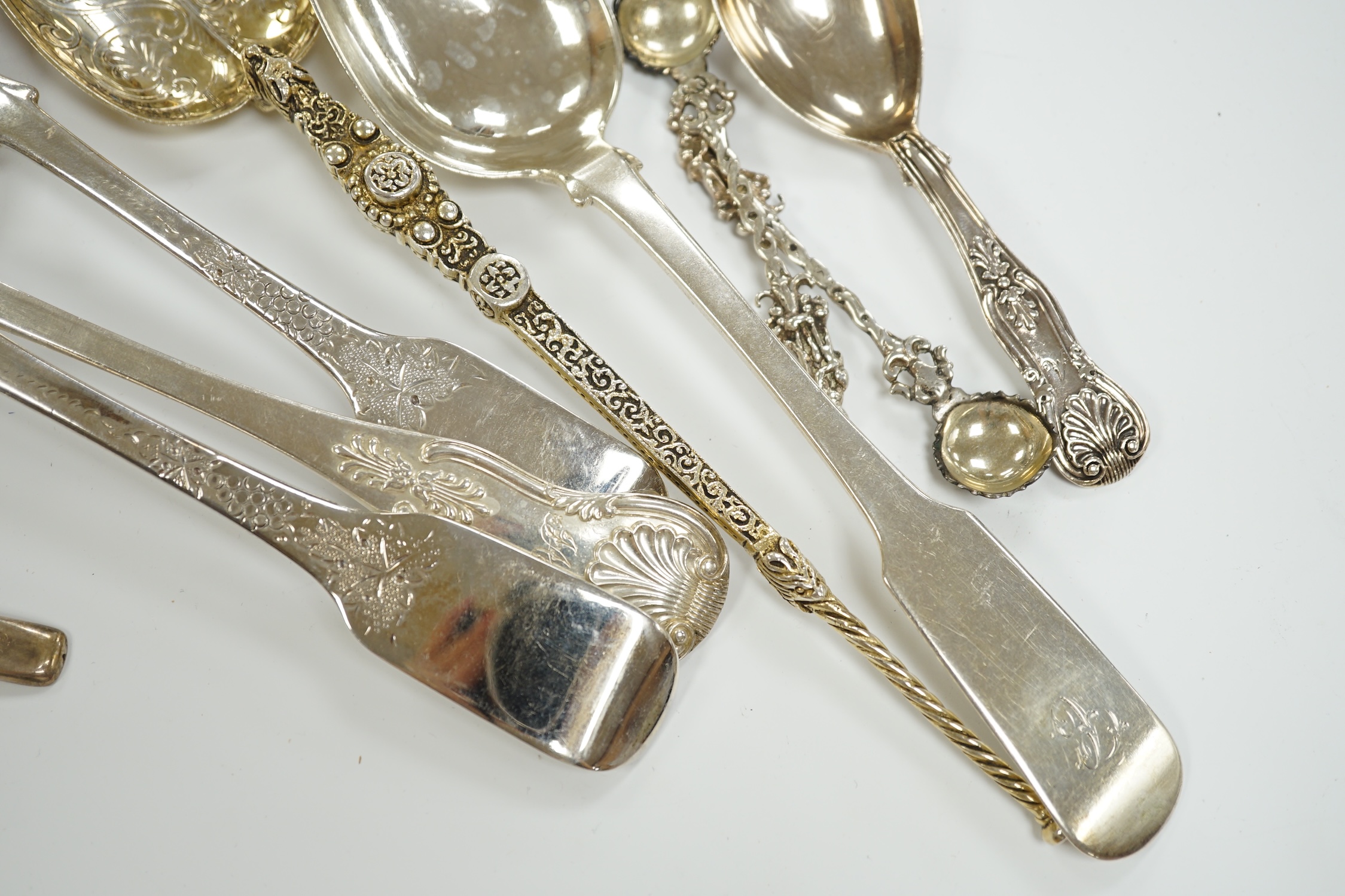 An Edwardian silver 'anointing spoon' Wakeley & Wheeler, London, 1901, 25.5cm, eight other silver spoons including two 19th century caddy spoons and a silver christening mug, 17.7oz.